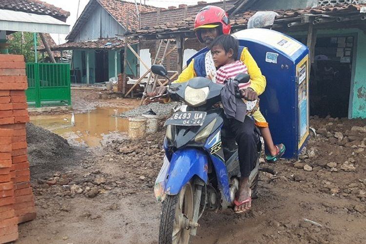 Viral, Tarmuji Penjual Roti Keliling Sambil Menggendong Putrinya yang Lumpuh