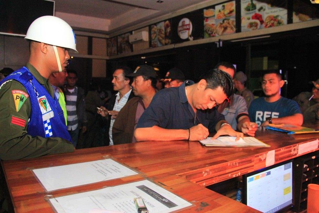 Foto: Petugas mendata pengunjung saat penggerebekan New D’Blues Karaoke, Spa dan Lounge yang berlokasi di Komplek Pertokoan Tata Plaza Jalan Kapten Muslim Medan, kemarin malam.