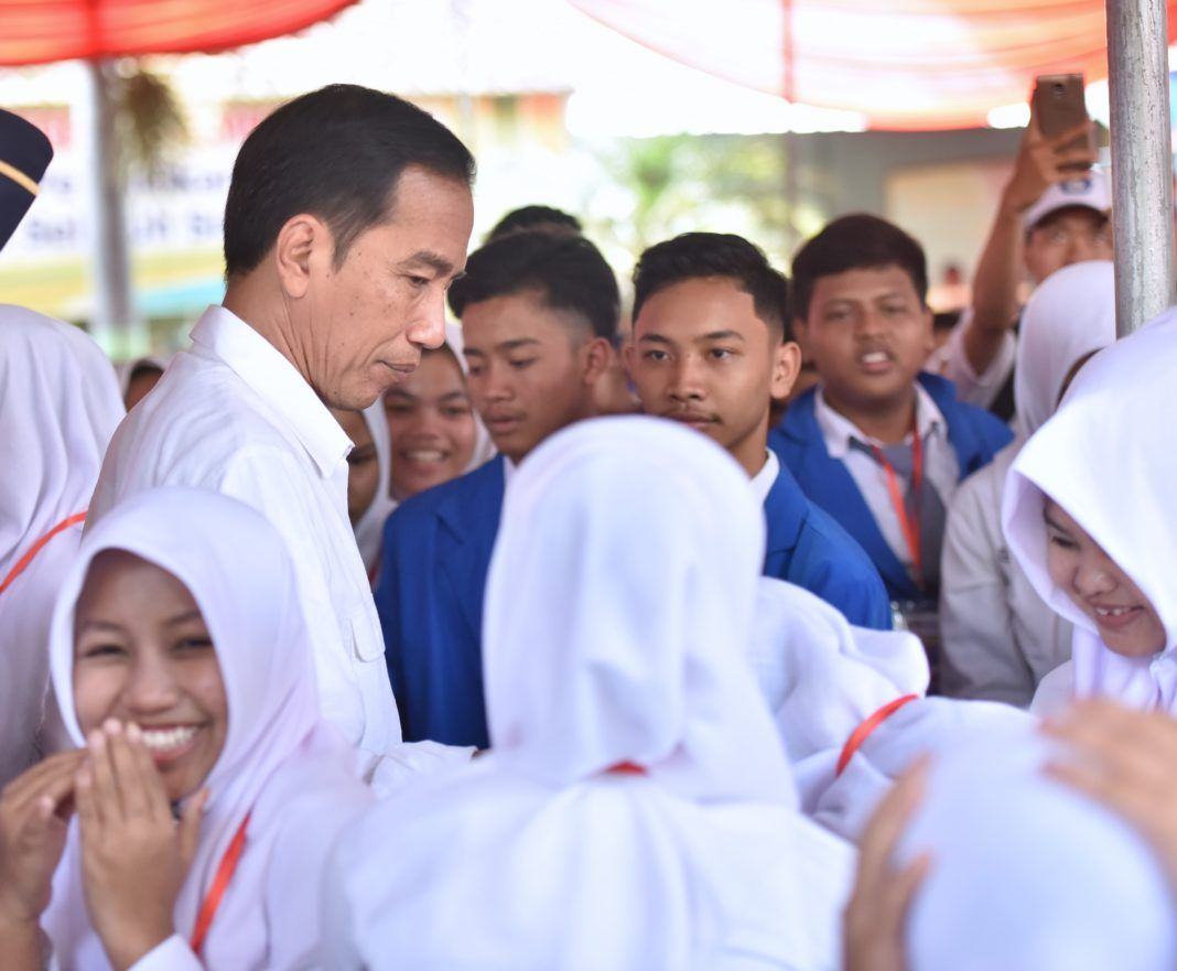 Foto: Presiden Jokowi di tengah siswa penerima KIP di SMP Negeri 7, Jalan Cenderawasih, Kabupaten Jember, Jatim, Minggu (13/8).